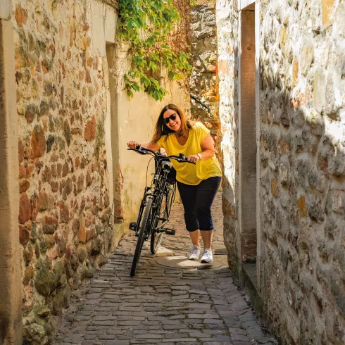 Frau mit Fahrrad in Freinsheimer Gasse
